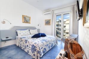a bedroom with a bed and a large window at Cafiero Flat in Sorrento