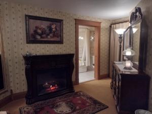 a living room with a fireplace and a mirror at The Historic Elk Mountain Hotel in Elk Mountain
