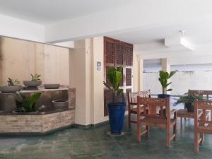 a patio with a table and chairs and plants at Apartamento 100 metros da Praia Grande/Ubatuba/SP in Ubatuba