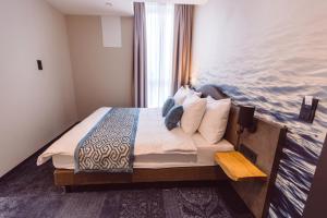 Postel nebo postele na pokoji v ubytování Hotel Libertas elements pure