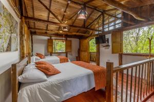 a bedroom with two beds and a balcony at Ecohotel Piedemonte in Salento