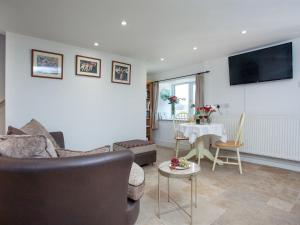 a living room with a couch and a table at Dunstone Cottage in Shaugh Prior