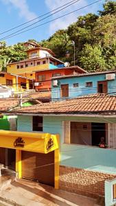 a building with a yellow and blue roof at Cantinho da Luna in Morro de São Paulo
