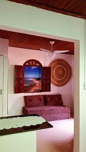 a room with a bed and a ceiling fan at Cantinho da Luna in Morro de São Paulo
