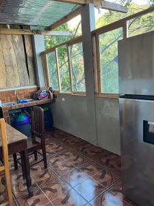 a kitchen with a table and a refrigerator at Hotel Berena in San Marcos La Laguna