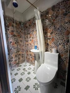 a bathroom with a toilet and a sink at Hotel Berena in San Marcos La Laguna