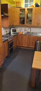 a kitchen with wooden cabinets and stainless steel appliances at City centre Flat - sleep upto 4 in Edinburgh