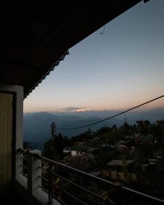 a view of the mountains from a balcony at MiakaHillsDarjeeling in Darjeeling