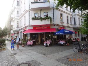 een vrouw die voor een restaurant met roze tafels staat bij Sybel in Berlijn
