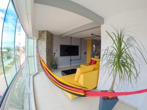 a hammock in the living room of a house at Tropical Tramandaí in Tramandaí