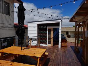 a patio with a table and a building at Redhill Cooma Motor Inn in Cooma