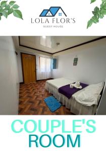 a hotel room with two beds in a room at Lola Flor's Guest House in El Nido