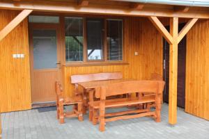 a wooden table and two chairs on a porch at U Mami in Veľký Meder