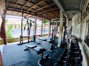 a gym with rows of treadmills and exercise bikes at JR&GYM Resort in Phi Phi Don