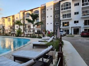 a resort with a swimming pool and a building at Armonia De Las Terrenas Gorgeous Penthouse in Las Terrenas