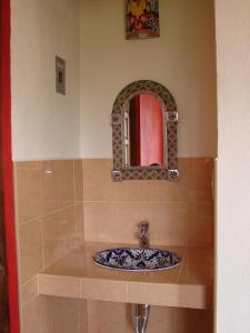 a bathroom with a sink and a mirror at Los Ócalos Villas in Huasca de Ocampo