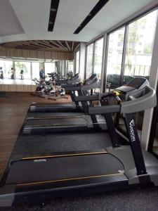 a gym with a row of treadmills and machines at SS CondoStay Residensi Lili, Nilai nearby KLIA, USIM - infinity pool, wifi, smart tv in Nilai