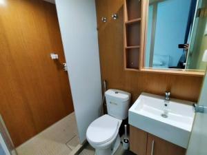 a bathroom with a toilet and a sink and a mirror at SS CondoStay Residensi Lili, Nilai nearby KLIA, USIM - infinity pool, wifi, smart tv in Nilai