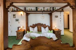 a bedroom with a wooden bed and two night stands at Vitusfort Appartement "Irish Whisky Suite" in Füssen