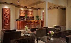 a restaurant with tables and chairs and a bar at Khmer House Resort in Siem Reap