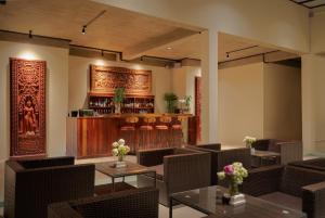 a restaurant with tables and chairs and a bar at Khmer House Resort in Siem Reap