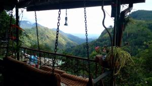 a view of the mountains from a swing at Secret View Homestay Ella in Ella