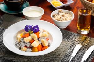 a bowl of fruit and vegetables on a table at Khmer House Resort in Siem Reap