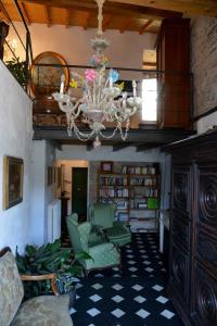 a living room with a chandelier and some chairs at La Terrazza di Vico Olivi B&B in Ventimiglia