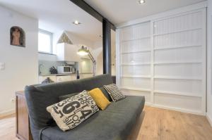 a living room with a gray couch with pillows at BmyGuest - Castelo Charming Flat in Lisbon