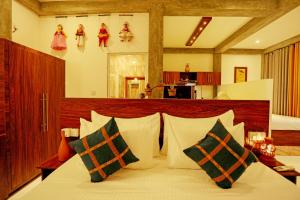 a bedroom with a bed with pillows on it at Villa Sanni 18 in Hikkaduwa