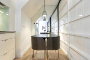 a kitchen with a black table in a room at BmyGuest - Castelo Charming Flat in Lisbon
