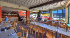 a restaurant with tables and chairs and people sitting in it at The Dannebrog Lodge in Devonport