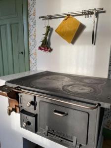 a stove top oven in a kitchen with a door at Charmig stuga på bondgård in Norrfjärden
