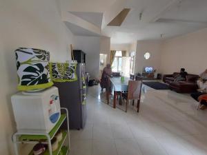 a kitchen and living room with a refrigerator and a table at Villa MountView No 88 Berastagi View in Berastagi