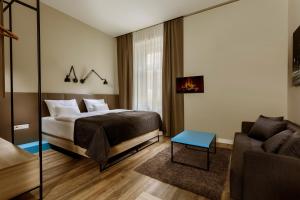 a bedroom with a bed and a couch at Avenue Legerova 19 in Prague