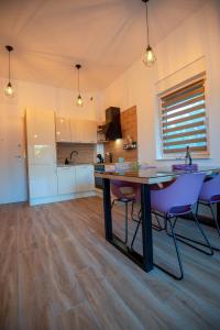 a kitchen with a table and chairs in a room at My Adriatic Place with private garden in Šibenik