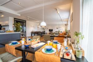 a living room with a table with food on it at Nieuw Leven Texel in Den Burg