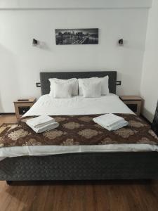 1 dormitorio con 1 cama con 2 toallas en Casa de la Nuc en Târgu Jiu