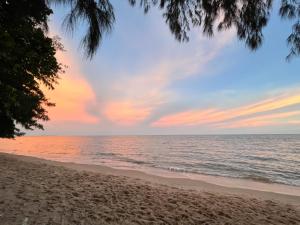 a view of the beach at sunset at Sky&Sea Cha-AM Beach in Cha Am