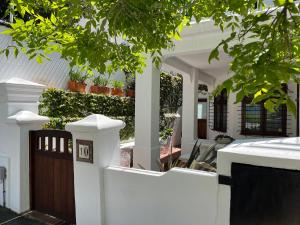 a white fence in front of a house at Belmont Guest House in Cape Town