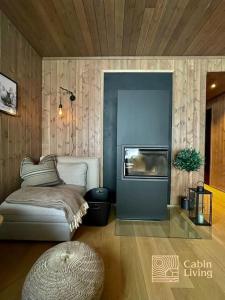 a living room with a couch and a fireplace at Brand new Chalet-apart slope Hafjell Mosetertoppen in Øyer