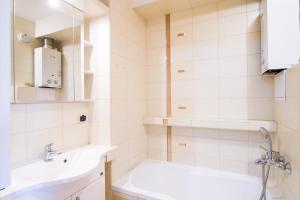 ein weißes Badezimmer mit einem Waschbecken und einem Spiegel in der Unterkunft Opalinskiego 19/96 in Przemyśl