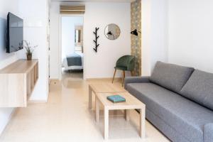 a living room with a couch and a table at CALMA Apartments in Benidorm