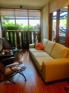 a living room with a couch and a chair at Private single room in Cigadung in Bandung