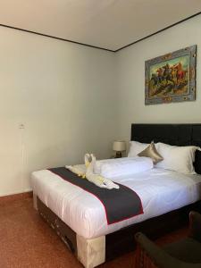 a bedroom with a bed with a stuffed animal on it at Guest House Pondok Puspa Ayu in Kuta
