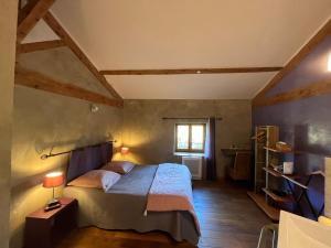 a bedroom with a large bed and a window at Domaine de Pipangaille in Andancette