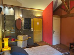 a room with a bed and a yellow door at Domaine de Pipangaille in Andancette