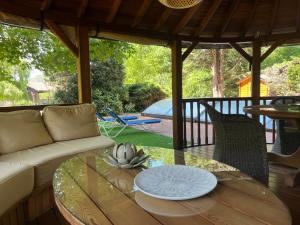 a living room with a couch and a glass table at Domaine de Pipangaille in Andancette