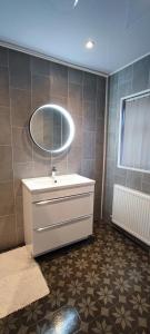 a bathroom with a sink and a mirror at Benllech Sea View bungalow, Dog Friendly sleeps 6 in Benllech