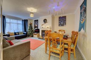 a living room with a table and chairs and a couch at Harry's House (Muggles welcome too!) in Watford